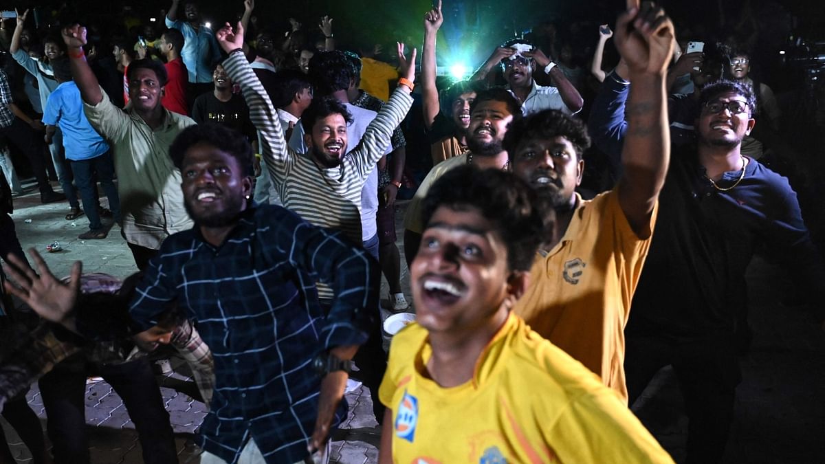 Chennai Super Kings fans celebrate their team's win, in Chennai. Credit: AFP Photo