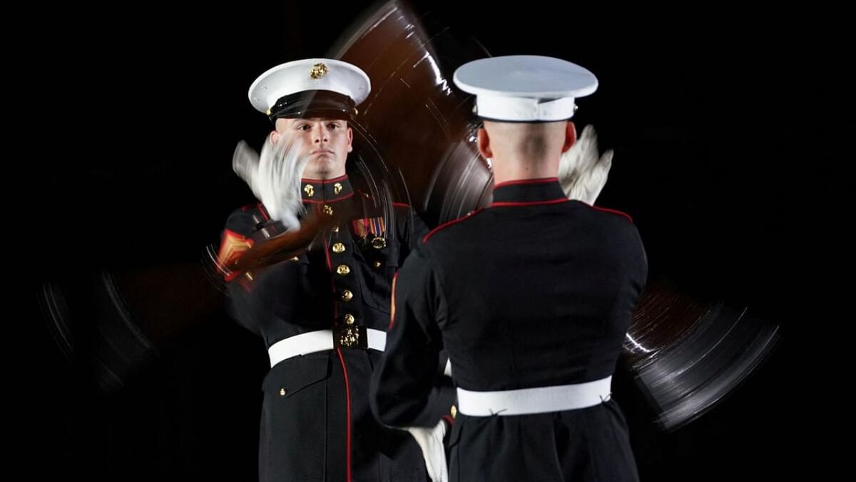 Rifles spin in the air as members of the Marine Corps Silent Drill Platoon perform at Friday Evening Parade at Marine Barracks, attended tonight by U.S. President Joe Biden, in Washington, U.S., June 2, 2023. Credit: Reuters Photo