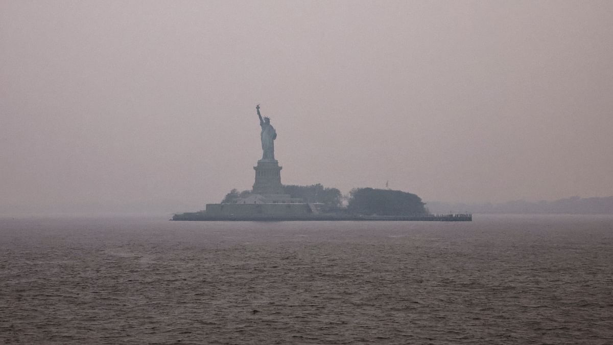The Statue of Liberty got covered in orange haze and smoke caused by wildfires in Canada travelling southwards towards New York City. Credit: Reuters Photo