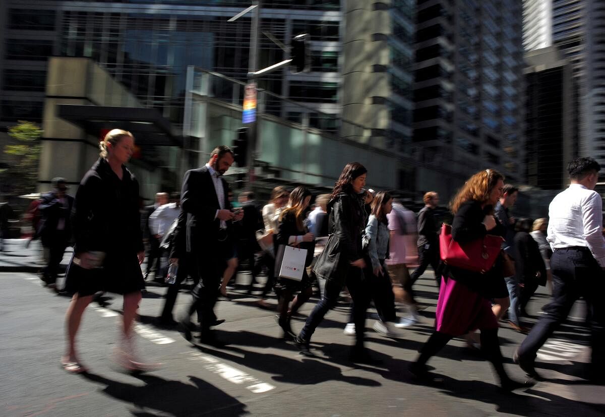 Office workers and shoppers walk through Sydney's central business district in Australia. Credit: Reuters Photo