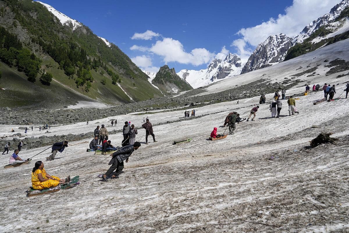 Tourists enjoy sledge ride at Thajiwas Glacier, in Sonamarg, Ganderbal district. Credit: PTI Photo