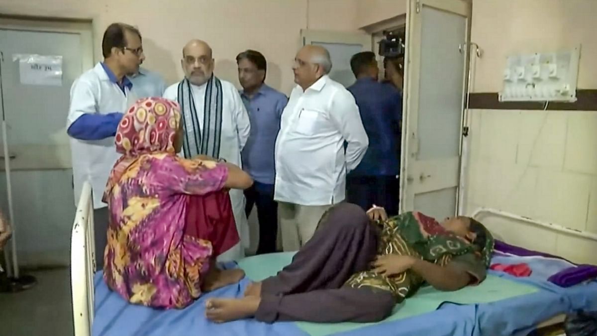 Union Home Minister Amit Shah and Gujarat Chief Minister Bhupendra Patel visit a government hospital to meet Cyclone Biparjoy-affected people, in Mandvi. Credit: Twitter/@HMOIndia