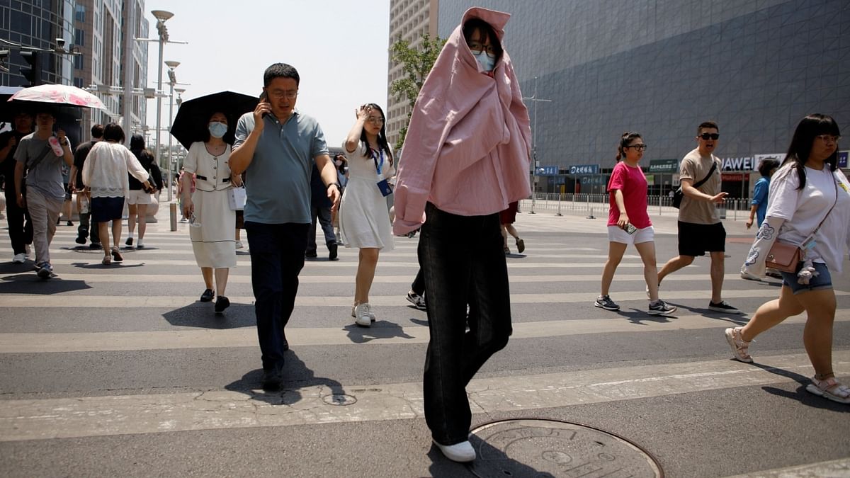 Opt for a comfortable attire: Wear lightweight, loose-fitting, and light-coloured clothing that covers your body, like long dresses and wide-brimmed hats. Credit: Reuters Photo