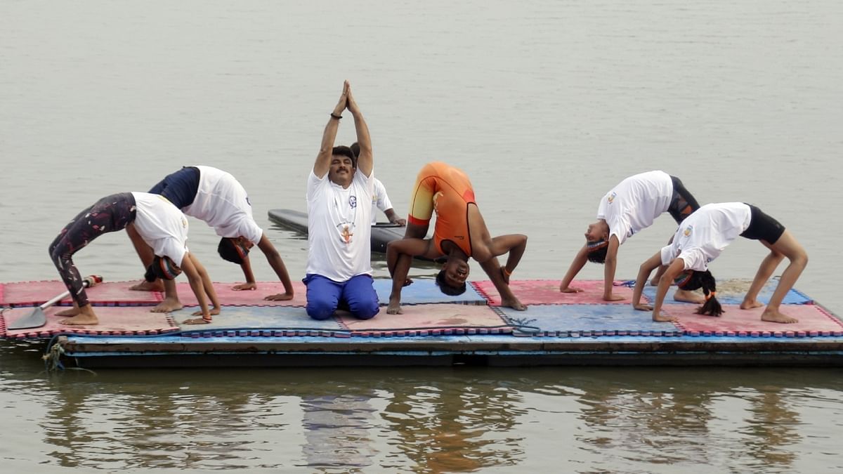 BJP MP Manoj Tiwari performs yoga during the 'International Day of Yoga' celebrations at Soniya Vihar, in New Delhi. Credit: IANS Photo
