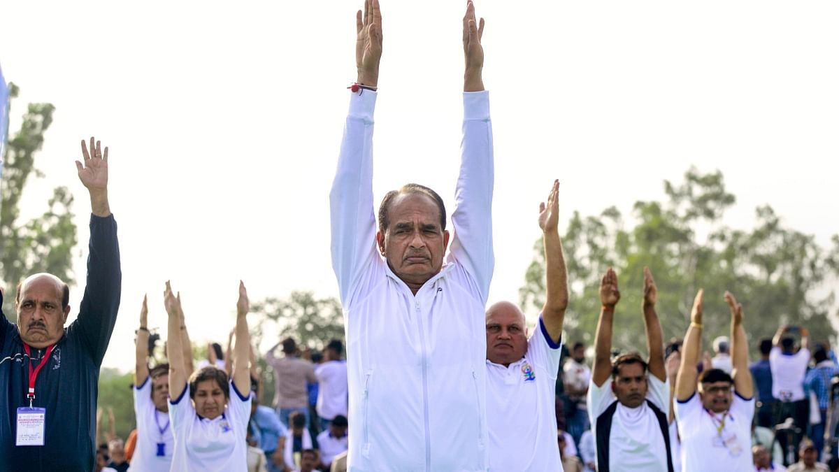 Madhya Pradesh Chief Minister Shivraj Singh Chouhan and others perform yoga on the International Day of Yoga, in Jabalpur. Credit: PTI Photo