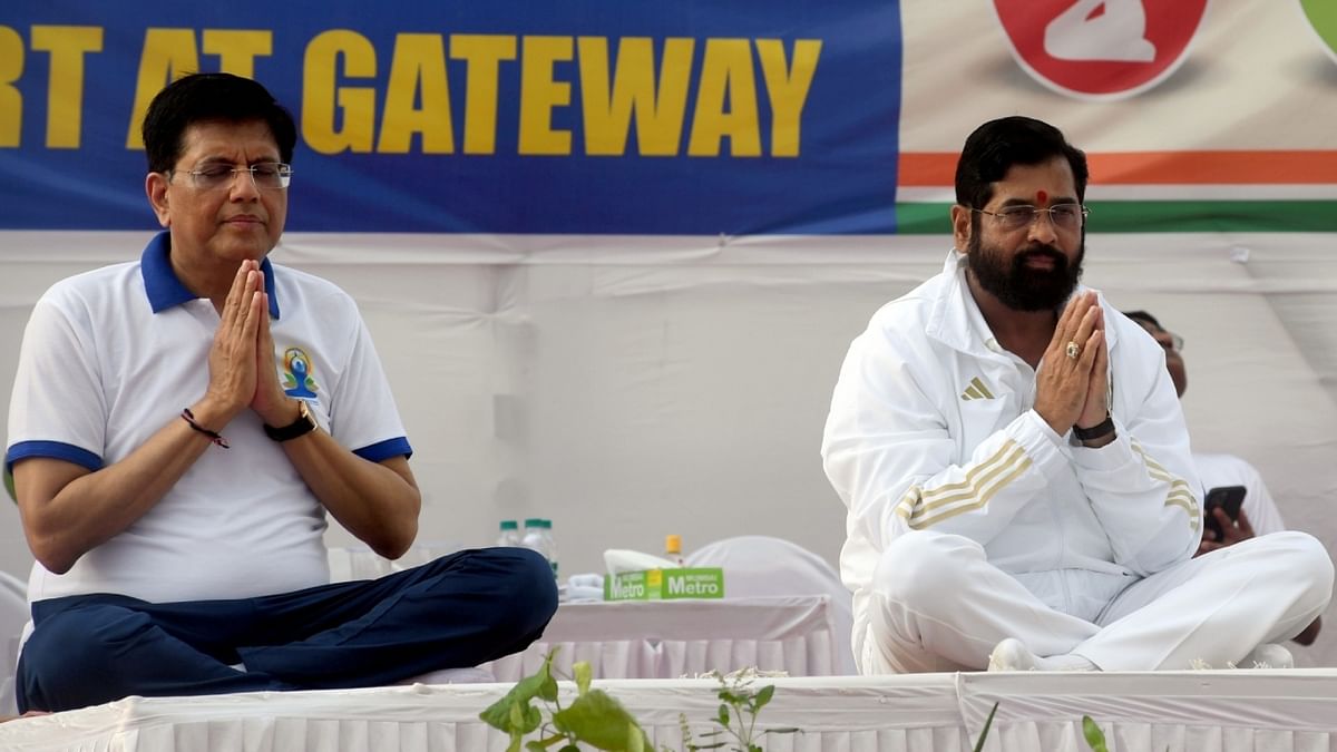 Former union minister Mukhtar Abbas Naqvi performs yoga at a programme organised on the International Day of Yoga, in Kasaragod. Credit: PTI Photo