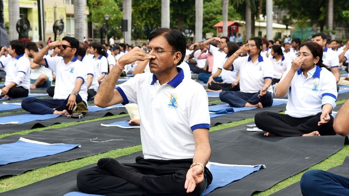 Union Minister Mansukh Mandaviya performs yoga during a International Day of Yoga event at the All India Institute of Medical Sciences (AIIMS), in New Delhi. Credit: IANS Photo
