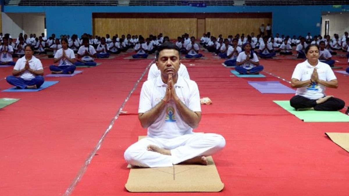 Goa Chief Minister Pramod Sawant performs yoga during a session on the 'International Day of Yoga' at Dr Shyama Prasad Mukherjee Stadium, in Goa. Credit: IANS Photo