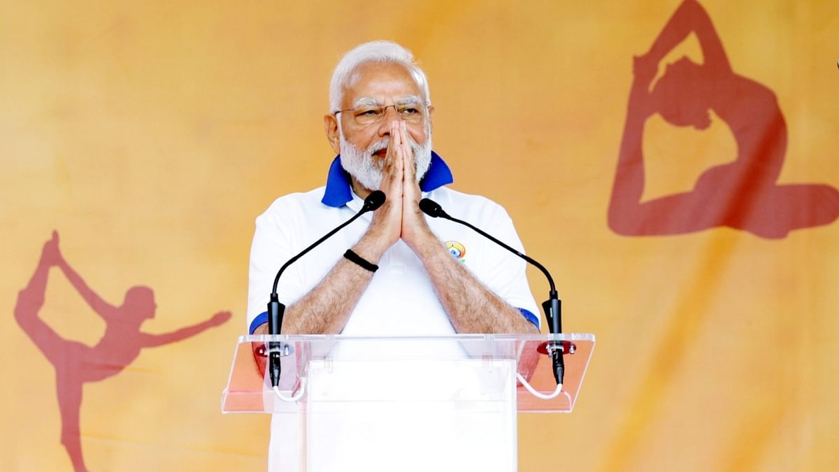 The Prime Minister, wearing a customised white yoga T-shirt and trousers, began his address with a 'Namaste' and thanked people for attending the celebration. Credit: PTI Photo