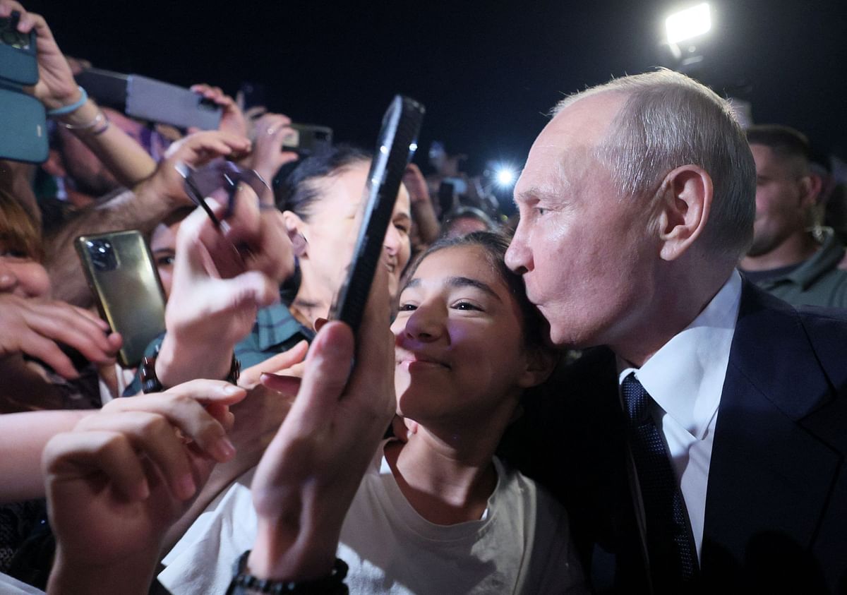 Russian President Vladimir Putin kisses a participant of a meeting in a street in Derbent in the southern region of Dagestan, Russia. Credit: Reuters Photo