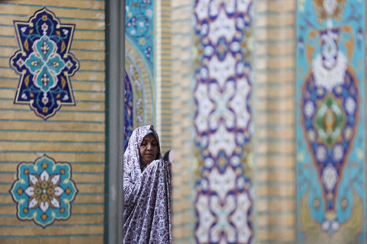 An Iranian woman prays on Eid al-Adha at the shrine of Abdol-Azim in Tehran, Iran. Credit: Reuters Photo