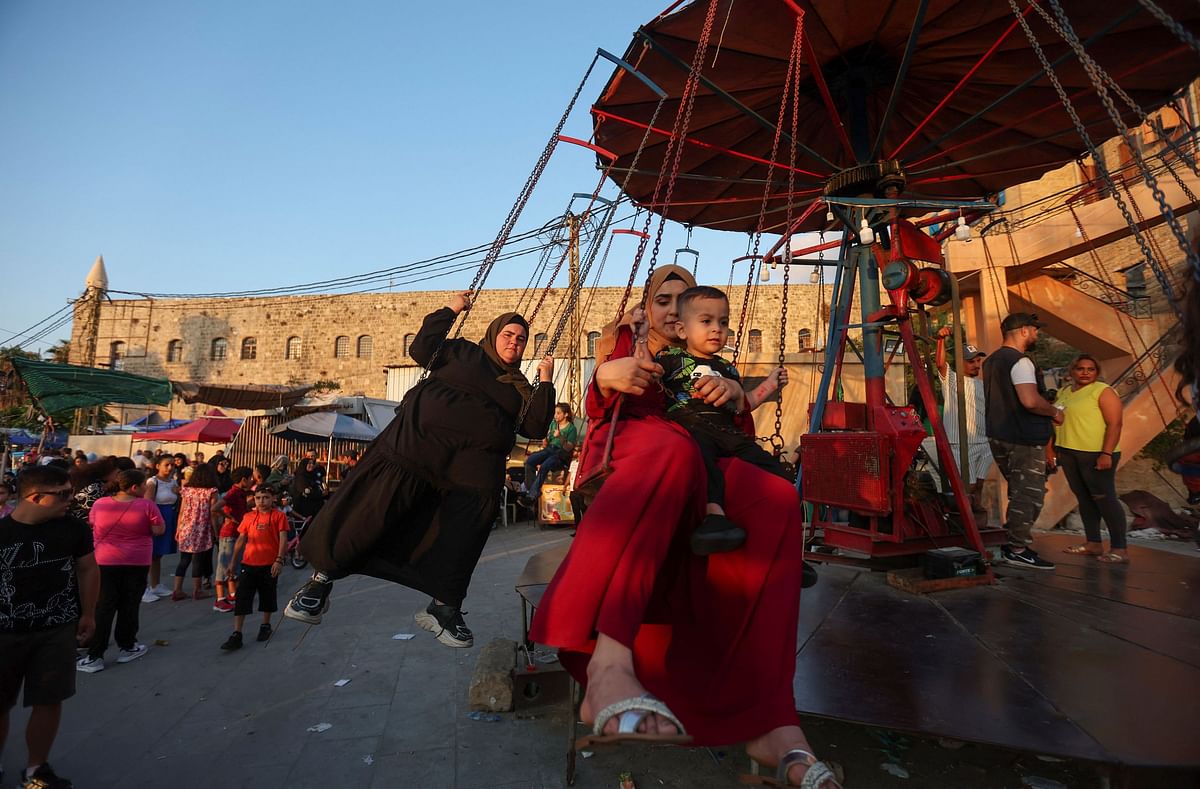 People enjoy a swing ride during the Muslim holiday of Eid al-Adha in Sidon, Lebanon. Credit: Reuters Photo