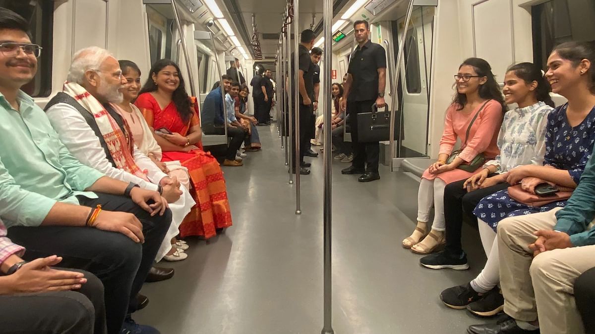 PM Modi was seen interacting with people on Delhi Metro while on his way to attend the centenary celebrations at Delhi University. Credit: PMO