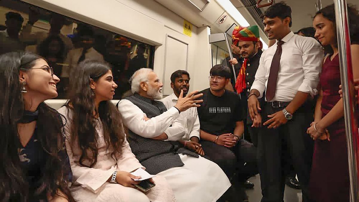 Officials shared pictures of Modi travelling on metro, sitting with commuters and interacting with them. Credit: Twitter/@narendramodi