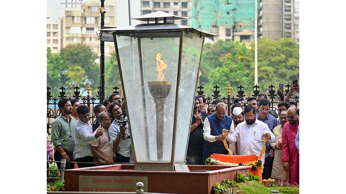 Maharashtra Chief Minister Eknath Shinde with his cabinet colleagues and others pay tribute to Shiv Sena founder Balasaheb Thackeray at his memorial on Guru Purnima, in Mumbai. Credit: PTI Photo