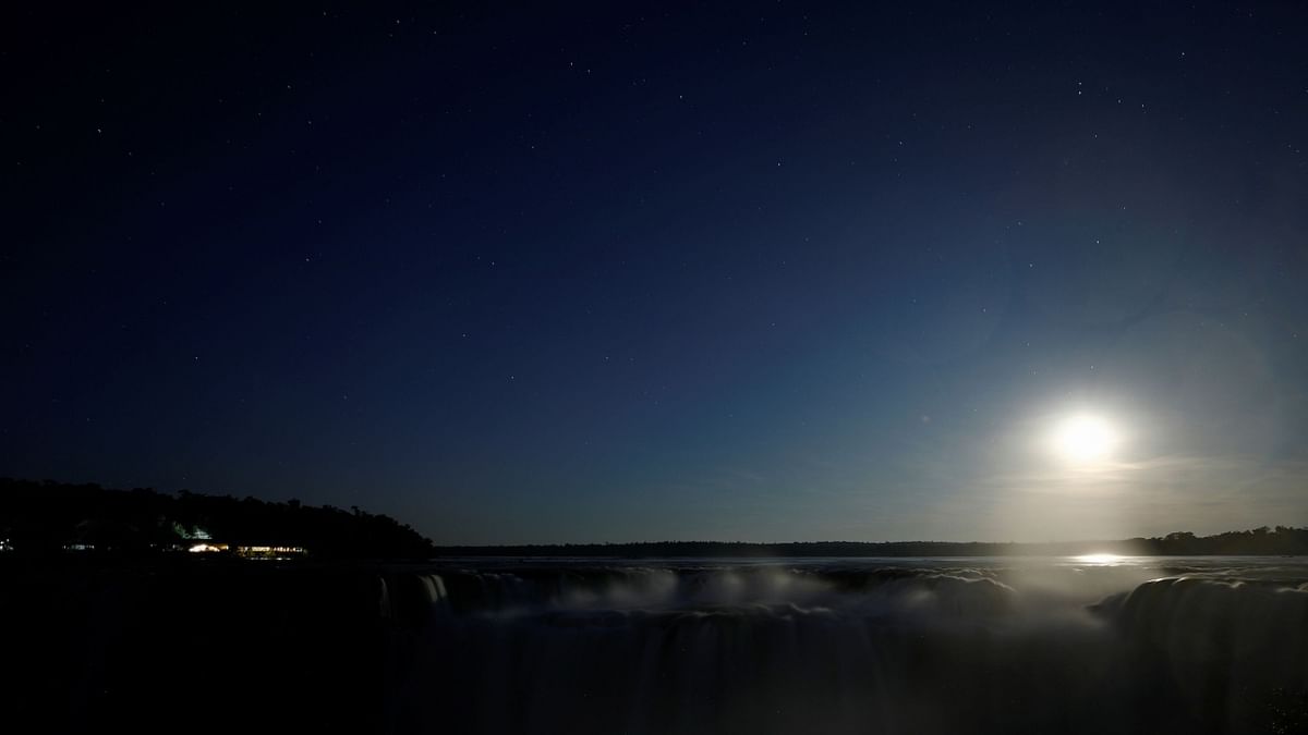 A full moon known as the 'Buck Moon' is seen as it rises behind the Iguazu Falls, on the Argentine side of the Iguazu River in Puerto Iguazu, Argentina. Credit: Reuters Photo