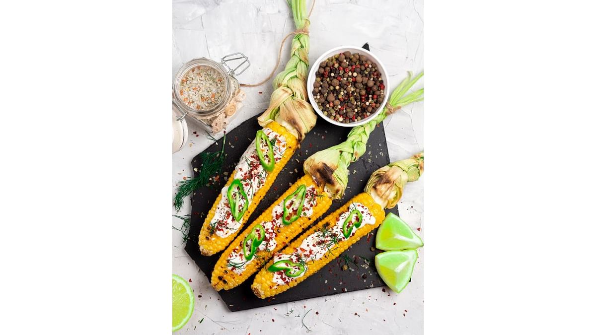 Roasted or boiled corn on the cob is a classic rainy day snack. Season it with salt, pepper, and a squeeze of lime for added flavor. Credit: Getty Images