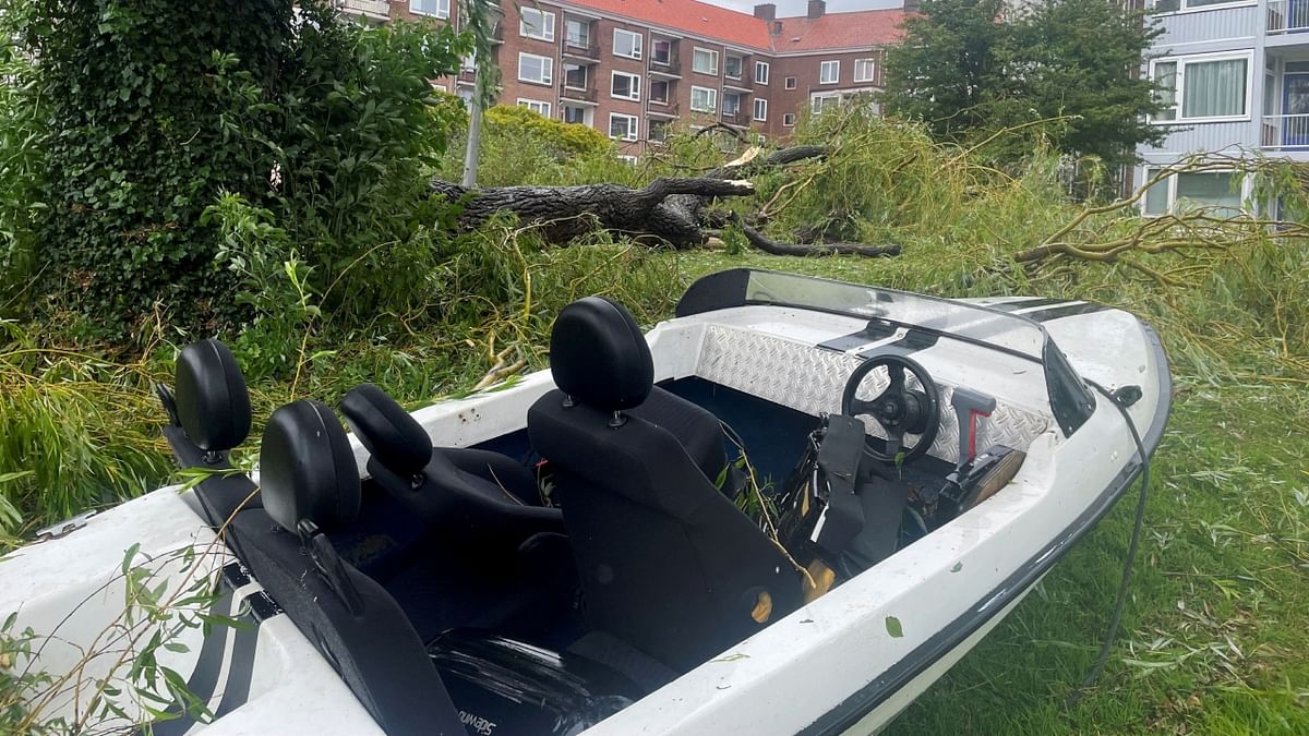 In Amsterdam, several people were injured as dozens of trees were toppled by the storm, damaging cars and houseboats along the city's canals. Credit: Reuters Photo
