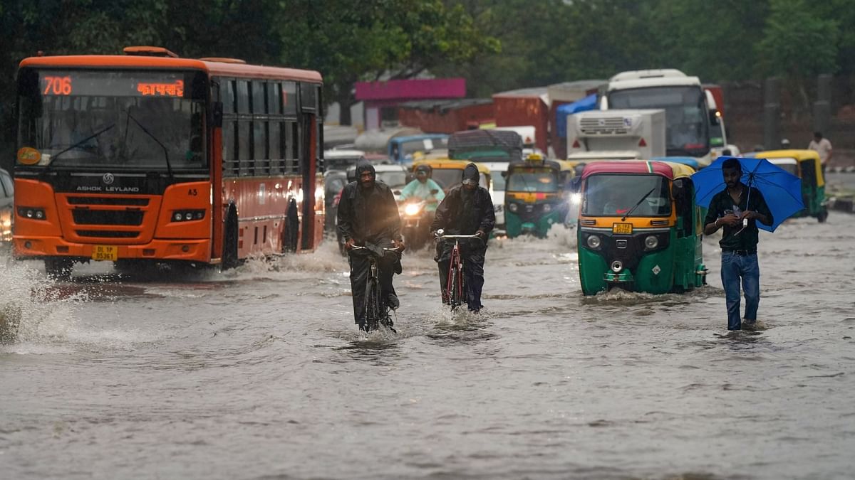 Traffic moves through a waterlogged road near Nigambodh Ghat after heavy monsoon rainfall, in New Delhi. Credit: PTI Photo
