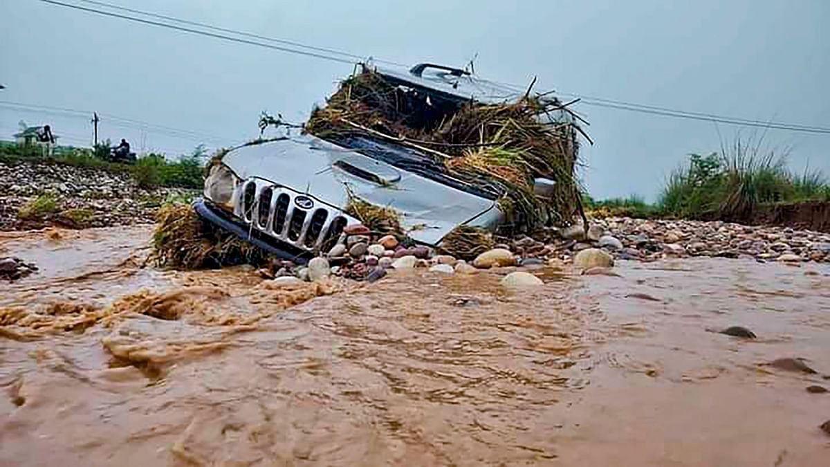 A car swept away in the water after flash floods occurred due to heavy monsoon rainfall, in Una. Credit: PTI Photo