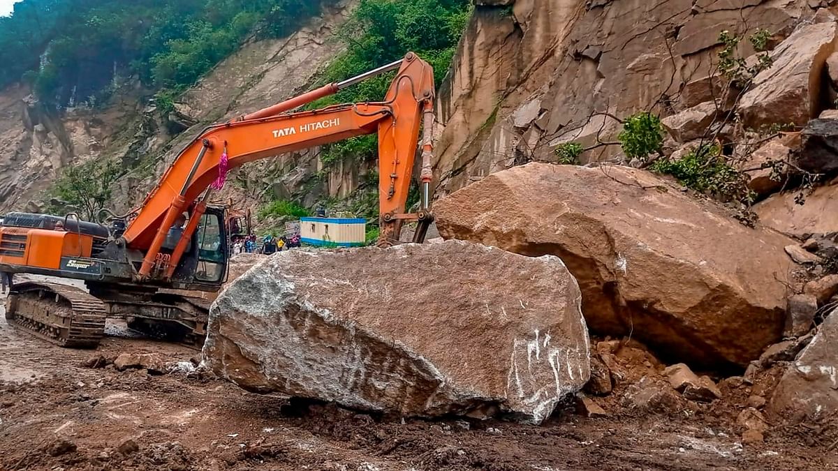 Heavy machinery being used to clear the blocked Chandigarh-Manali highway following a landslide triggered by incessant rain, in Mandi. Credit: PTI Photo