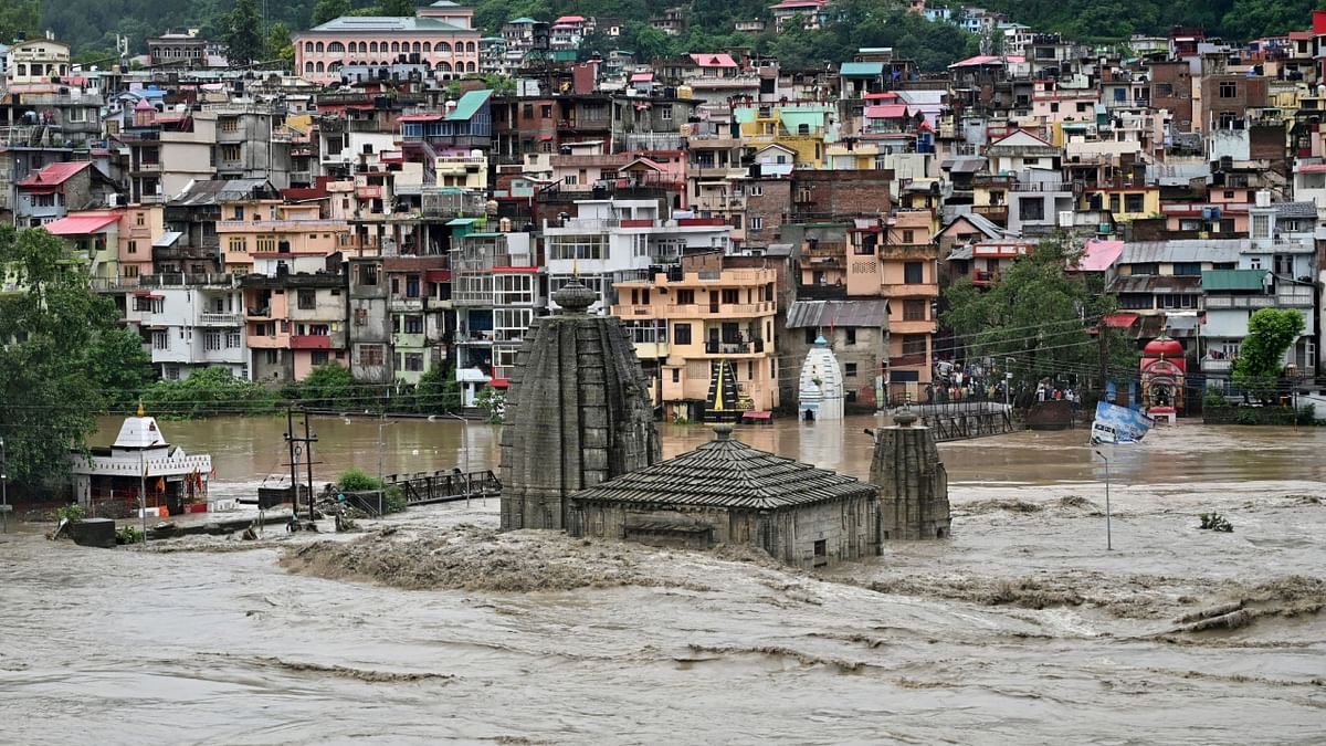 A temple gets submerged in water as the river Beas overflows following heavy rains in Mandi in Himachal Pradesh. Credit: Reuters Photo