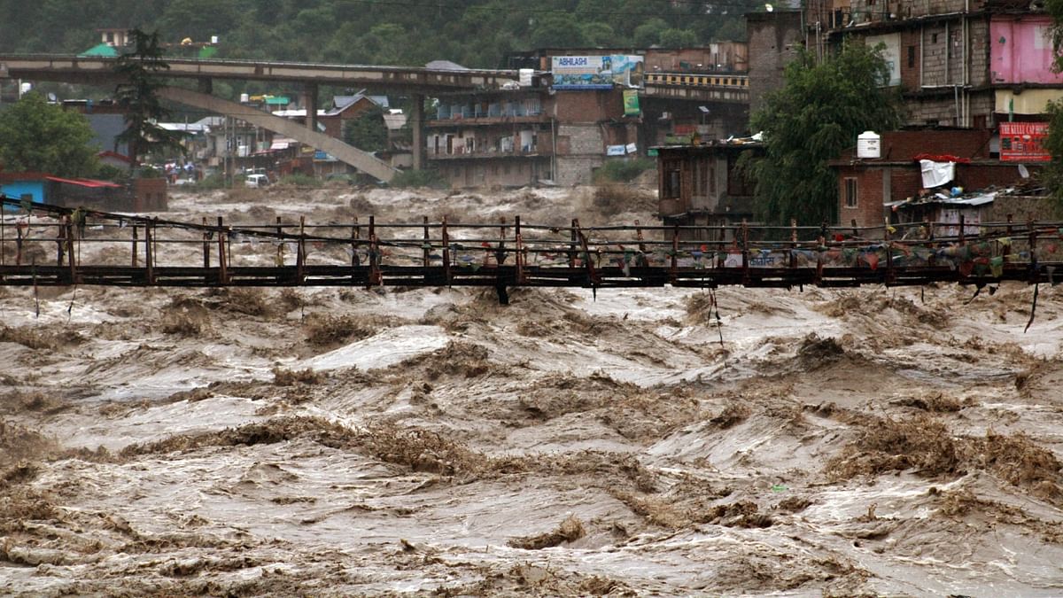 A portion of the Bhuntar Valley Bridge was washed away in the swollen Beas river owing to incessant monsoon rainfall, in Kullu. Credit: PTI Photo