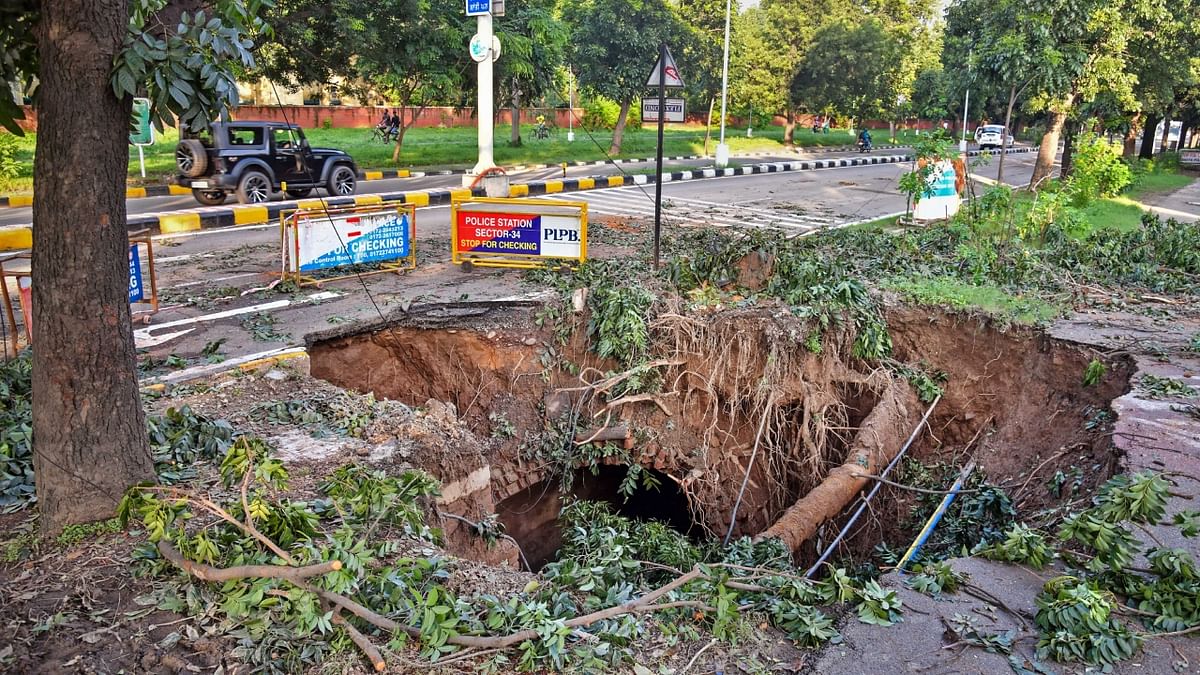 A section of a road caved in due to heavy monsoon rains in Chandigarh. Credit: PTI Photo