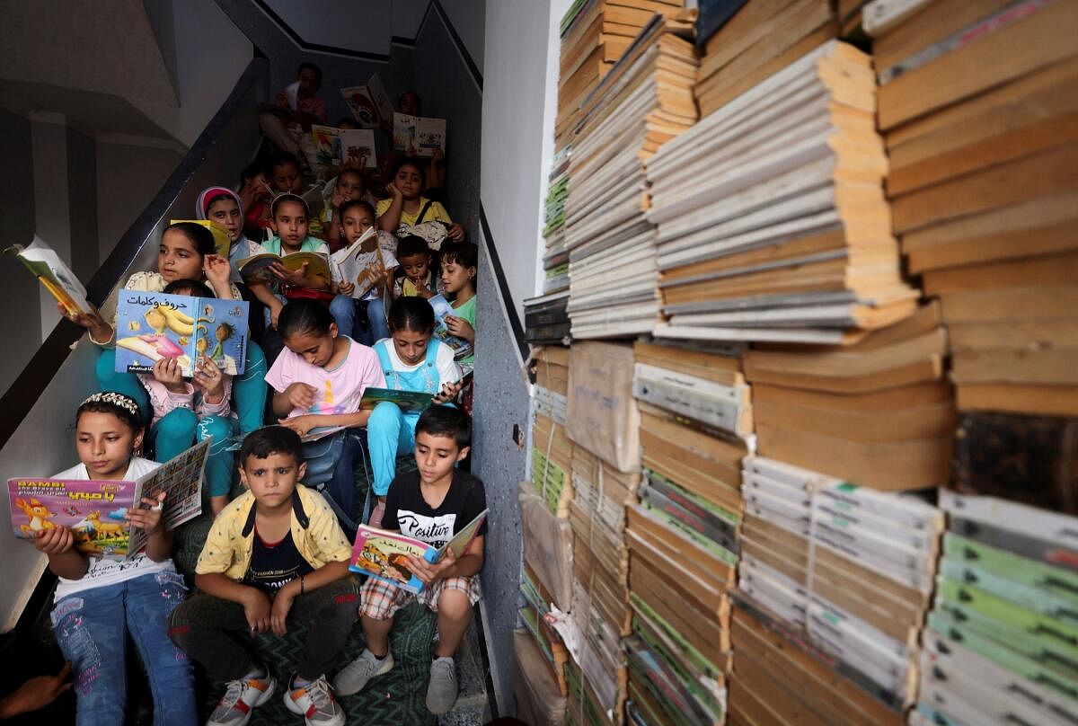 Children read books that they borrowed, at Mohamed Abdel Aziz's house which has been turned into a free learning centre for village students who lack access to cultural services and activities, at Bishet Amer village in the Sharqia Governorate, north of Cairo. Credit: Reuters Photo