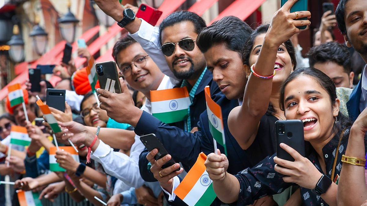 Indian community members gather to welcome Prime Minister Narendra Modi upon his arrival in Paris, France. Credit: PTI Photo