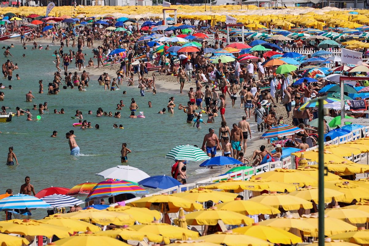 People cool off at Mondello beach, during a heatwave across Italy, in Palermo. Credit: Reuters Photo