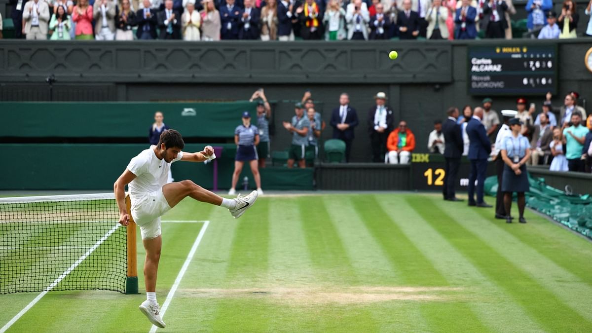 Carlos Alcaraz celebrates after winning his maiden Wimbledon title. Credit: Reuters Photo
