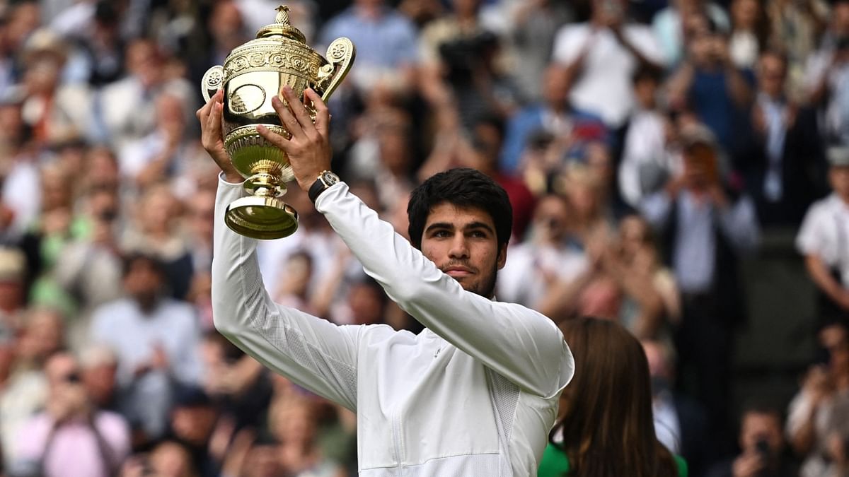 Carlos Alcaraz lifts Wimbledon trophy after his triumph over Novak Djokovic in the Wimbledon 2023 men's singles final in London. Credit: Reuters Photo