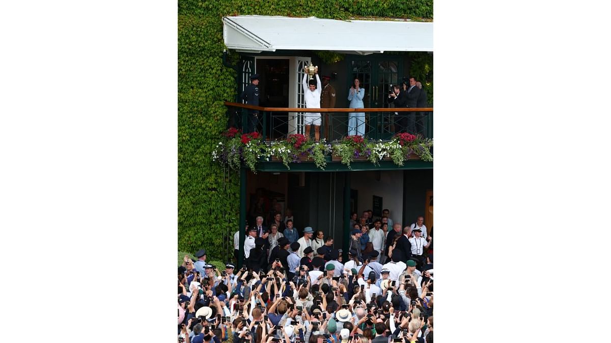 Alcaraz spotted on the balcony with the trophy after winning his final match against Serbia's Novak Djokovic. Credit: Reuters Photo