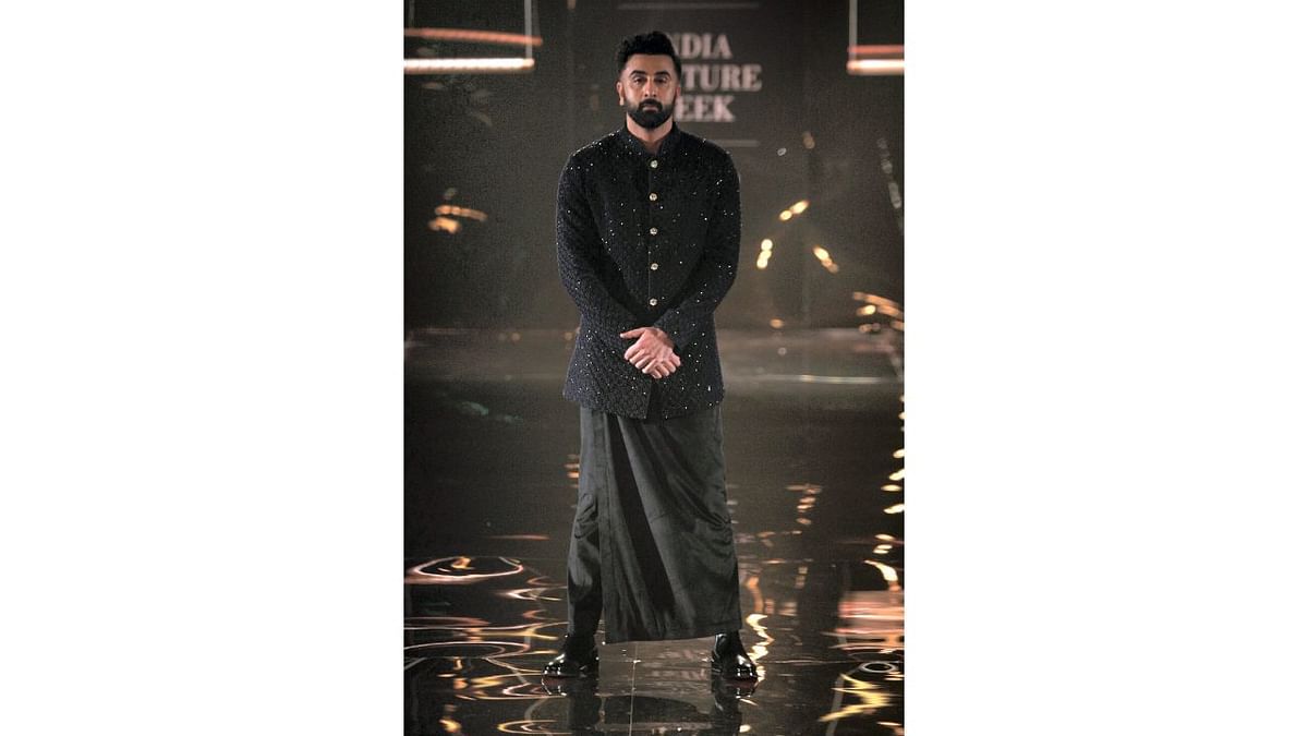 Ranbir Kapoor walked the ramp at the FDCI Hyundai India Couture Week (ICW) for celebrity designer Kunal Rawal. He wore a black contemporary bandhgala designed by Kunal as a part of his couture collection. Credit: PTI Photo