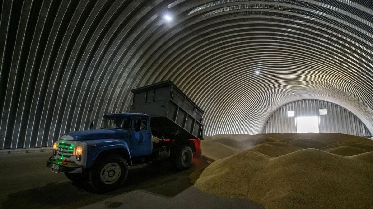 An employee unloads wheat grains inside a storage in the village of Zghurivka, amid Russia's attack on Ukraine, in Kyiv region. Credit: Reuters Photo