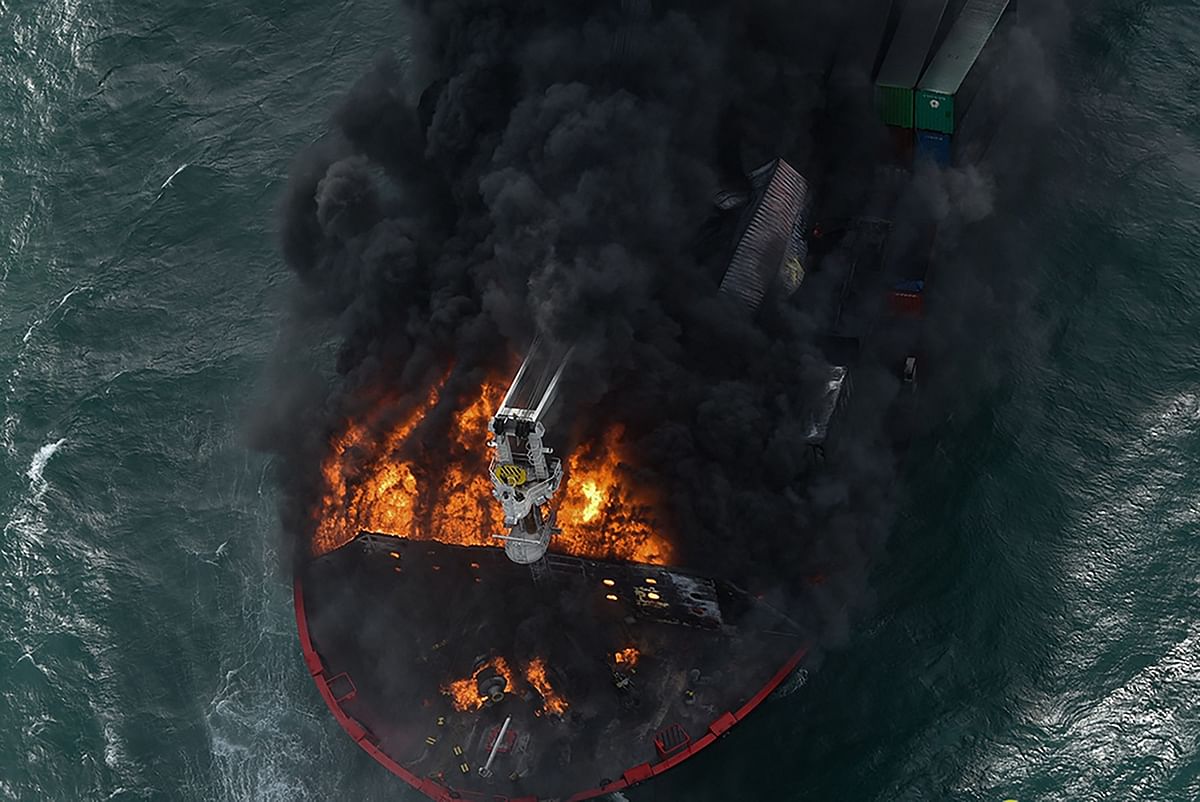 Flames and thick smoke billowing from the Singapore-registered container ship MV X-Press Pearl, which has been burning for the seventh consecutive day. Credit: AFP Photo