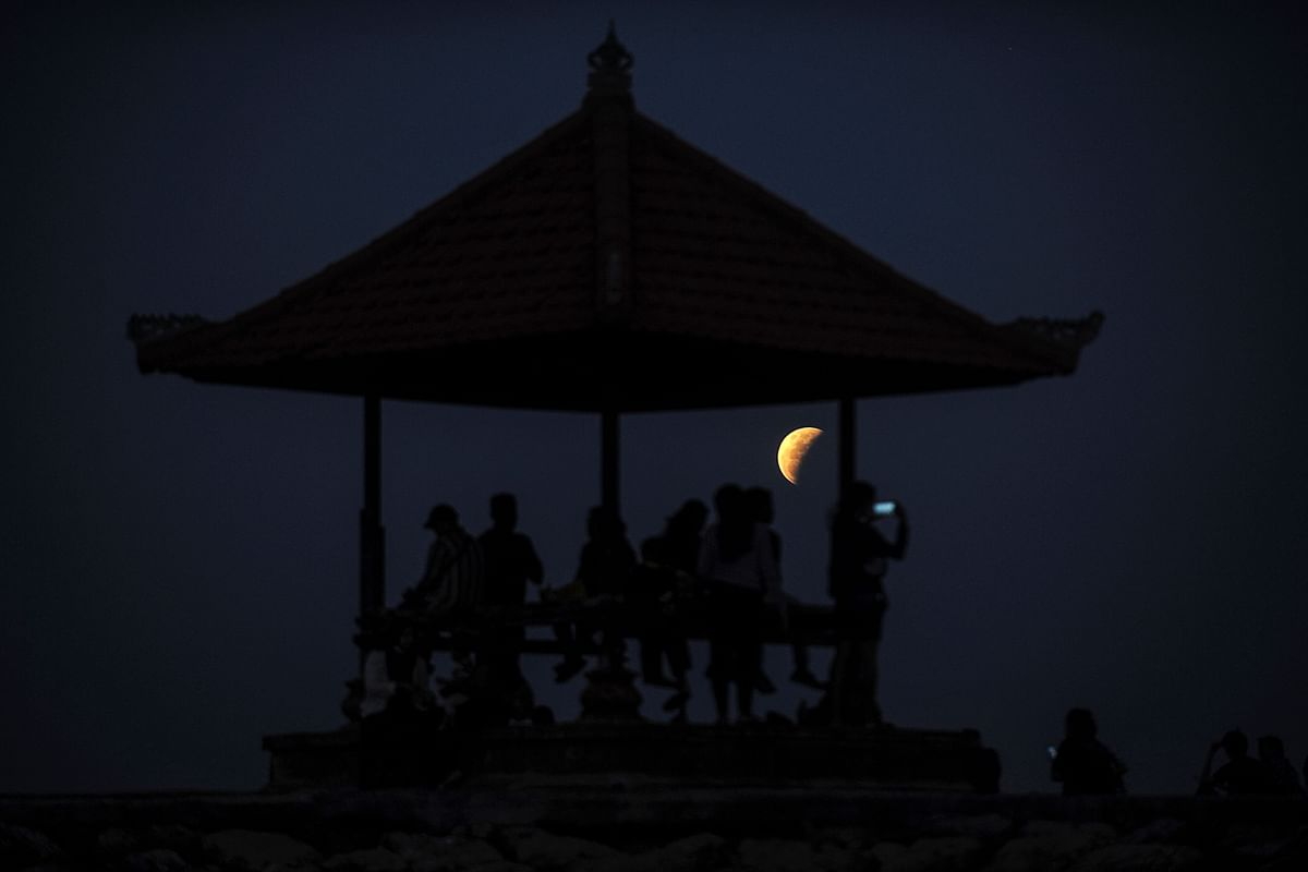 The moon is pictured from Sanur beach on the Indonesian resort island of Bali. Credit: AFP Photo