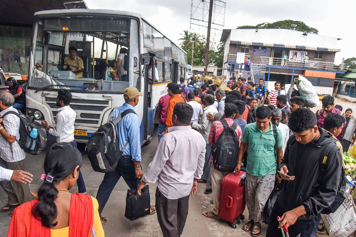 So many people wait for buses near K R Puram railway station where buses are the lifeline. (DH Photo/S K Dinesh)