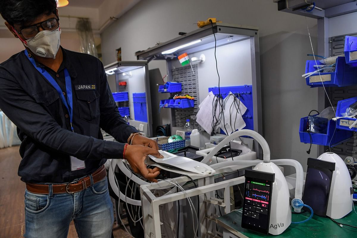 AgVa Healthcare employee Vaibhav Gupta demonstrates using a ventilator at the research and development (R&D) centre in Noida in Uttar Pradesh. (AFP)