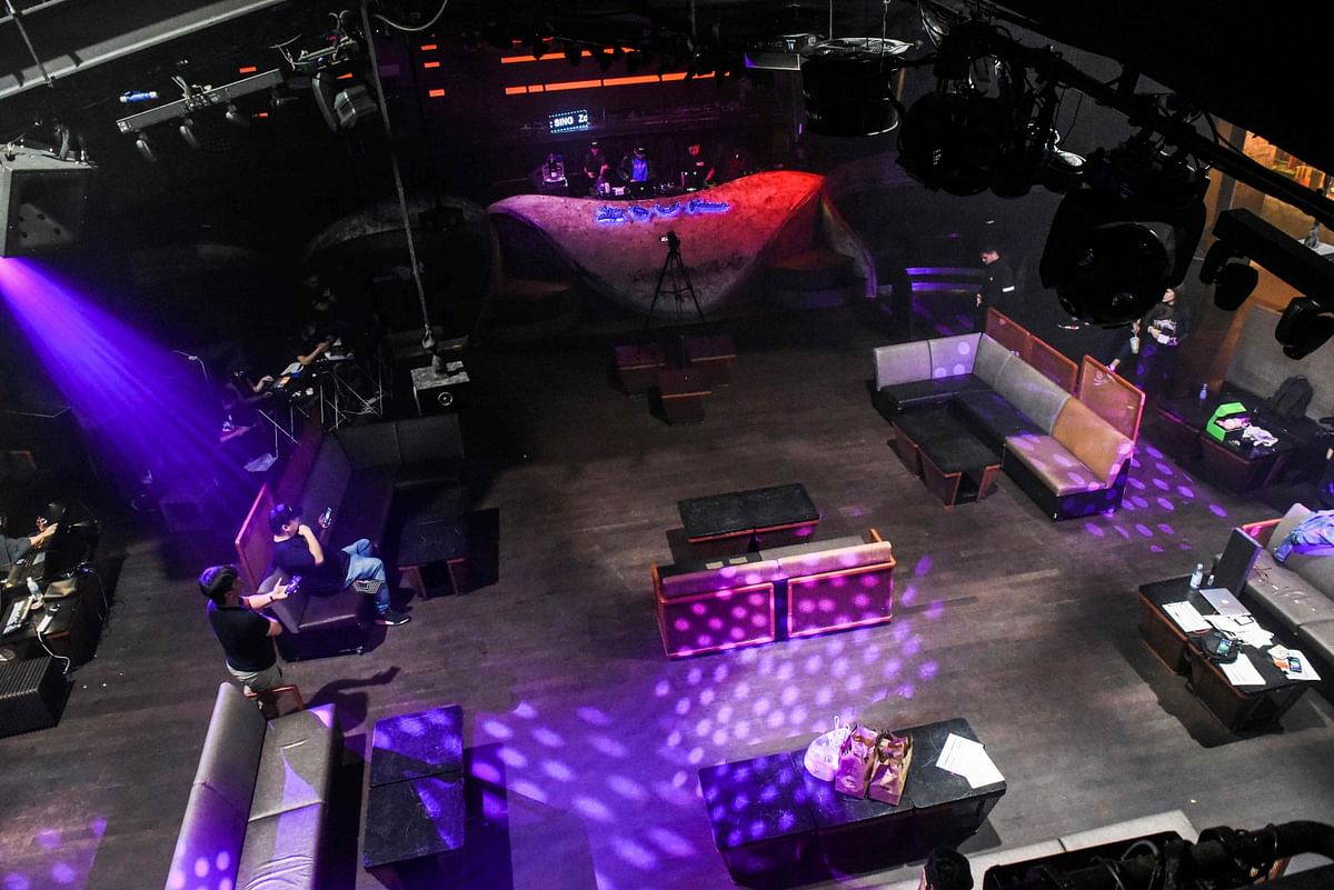 Zouk's DJs (top) performing in front of a video camera in the empty club during a