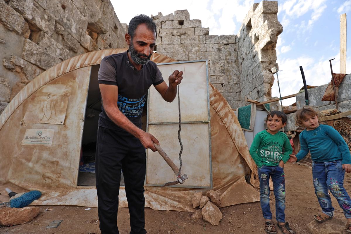 Displaced Syrians are pictured on November 1, 2020 in their makeshift camp amid Roman ruins in the area of Baqirha in northwest Syria not far from the Turkish border. - Almost one million Syrians fled their homes last winter during a Russia-backed offensive on Syria's last rebel stronghold of Idlib, and dozens of them have settled in the UNESCO-listed site of Baqirha, near the Turkish border, among centuries-old Roman and Byzantine ruins.Credit: AFP Photo