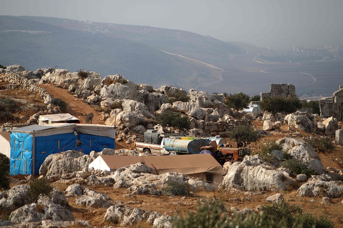 Tents housing Syrians displaced by war sit amid the ruins on November 1, 2020 at the UNESCO-listed site of Baqirha not far from the Turkish border, in a region of northwest Syria filled with abandoned Roman and Byzantine settlements. - Almost one million Syrians fled their homes last winter during a Russia-backed offensive on Syria's last rebel stronghold of Idlib, and dozens of them have settled in the UNESCO-listed site of Baqirha, near the Turkish border, among centuries-old Roman and Byzantine ruins. Credit: AFP Photo