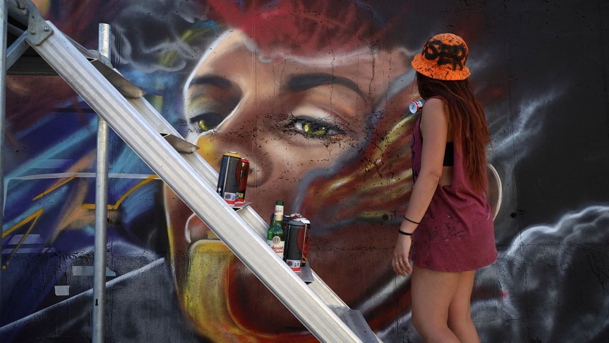 Liliana Demitri, a graffiti artist from Italy, paints a mural as part of the Meeting of Styles graffiti festival in Kosovo's capital Pristina, Kosovo July 29, 2023. Credit: Reuters Photo