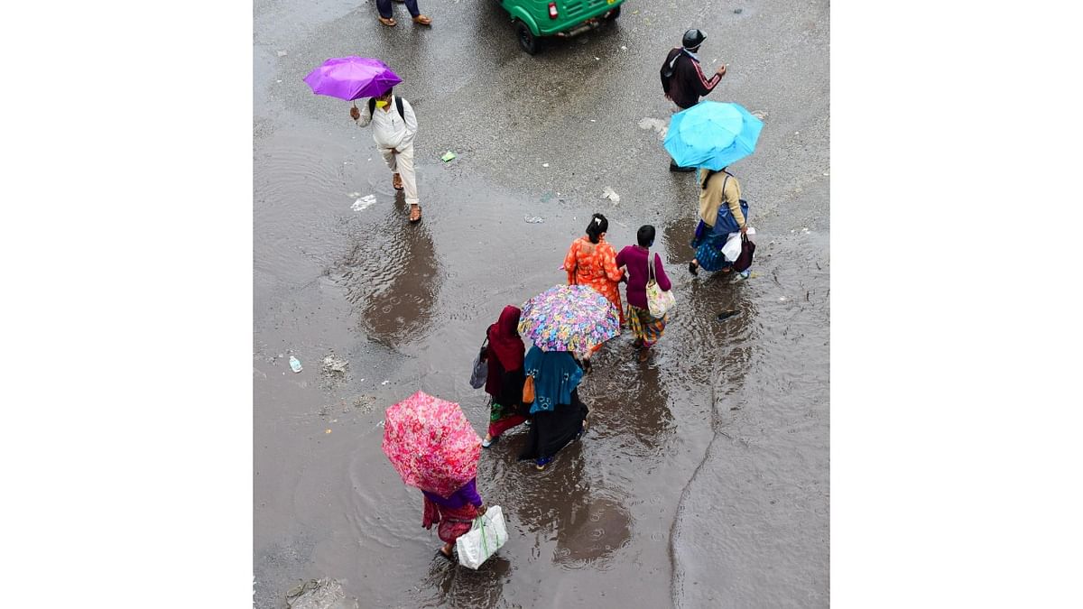 A rain-filled road at Kalasipalya. Credit: DH Photo/M S Manjunath