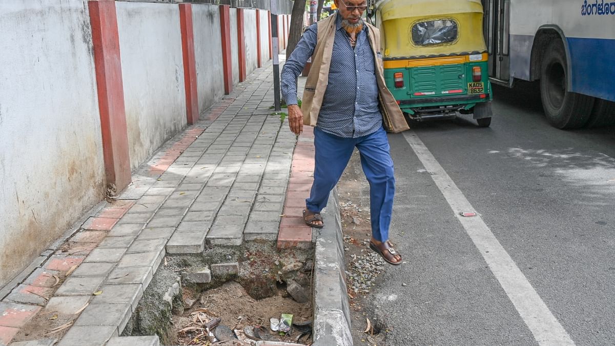 This footpath near Minerva Circle is broken in 10 places such as this. A Smart City project work is underway. Credit: DH Photo