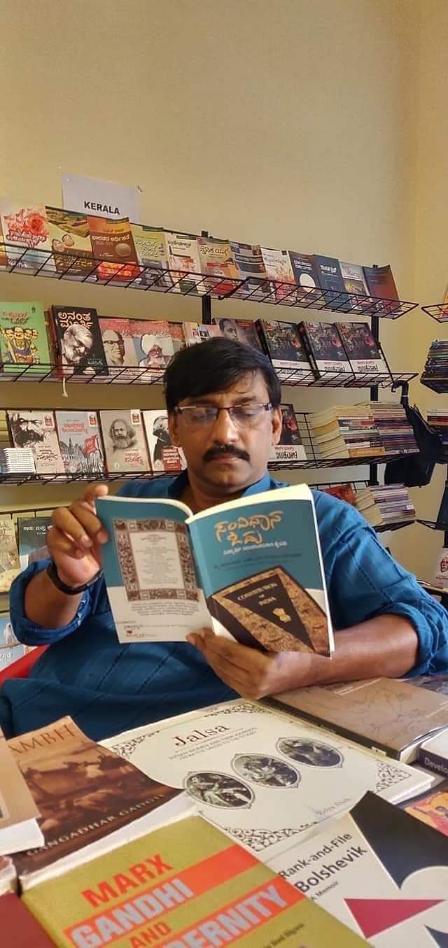 The late Vittal Bhandari, a cultural activist and intellectual, reading a copy of the Samvidhana Odu