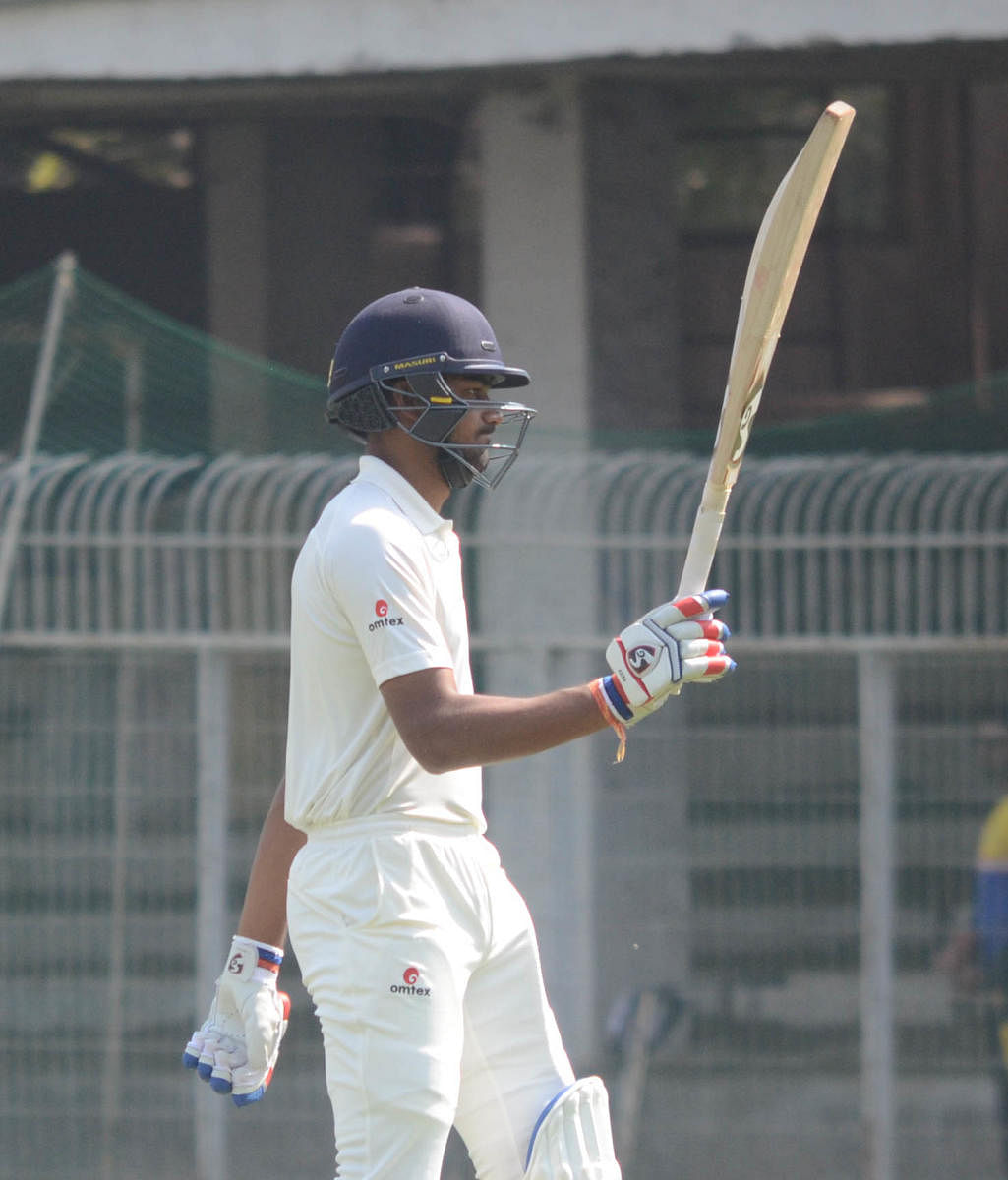 Karnataka opener D Nischal acknowledges his team-mates after his century against Vidarbha in Nagpur on Wednesday. DH Photo