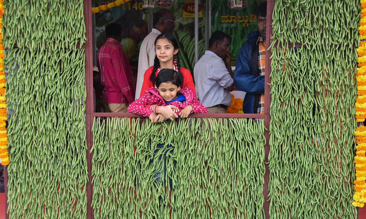 Children pose in front of a frame made out of beans at the Krishi Mela at the Gandhi Krishi Vigyan Kendra campus on Friday. DH PHOTOS/M S MANJUNATH