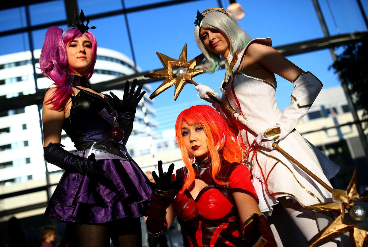 Cosplayers costumed as characters from the online video game